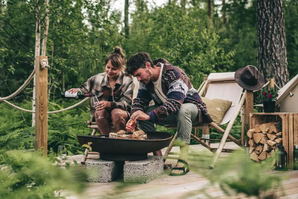 man and woman by the campfire